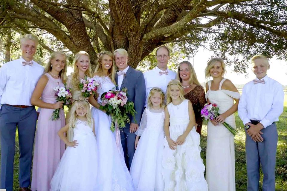 TLC Olivia and Ethan Plath at their wedding with siblings Micah, Lydia, Hosanna, Mercy, Cassia, Amber, Moriah and Isaac and parents Barry and Kim in 2018.