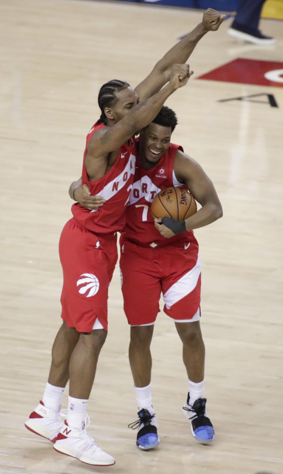 Toronto Raptors forward Kawhi Leonard #2 celebrates with teammate Kyle Lowry #7 at the conclusion of the NBA Finals Championships Game 6 between the Toronto Raptors at Golden State Warriors at Oracle Arena in Oakland, California. (Photo by EPA/MONICA M DAVEY)