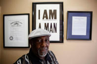 Henry Leach poses for a photograph as he stands under a commemorative "I am a Man" sign at Ms. Girlees's Soul Food restaurant in Memphis, Tennessee, U.S., March 29, 2018. Leach, who participated in the strike 50 years ago, said King came to the city for justice, not violence. "He came to help us get what we wanted. Like I tell you, he became like a father to us," the former sanitation worker, said recently. REUTERS/Jonathan Ernst