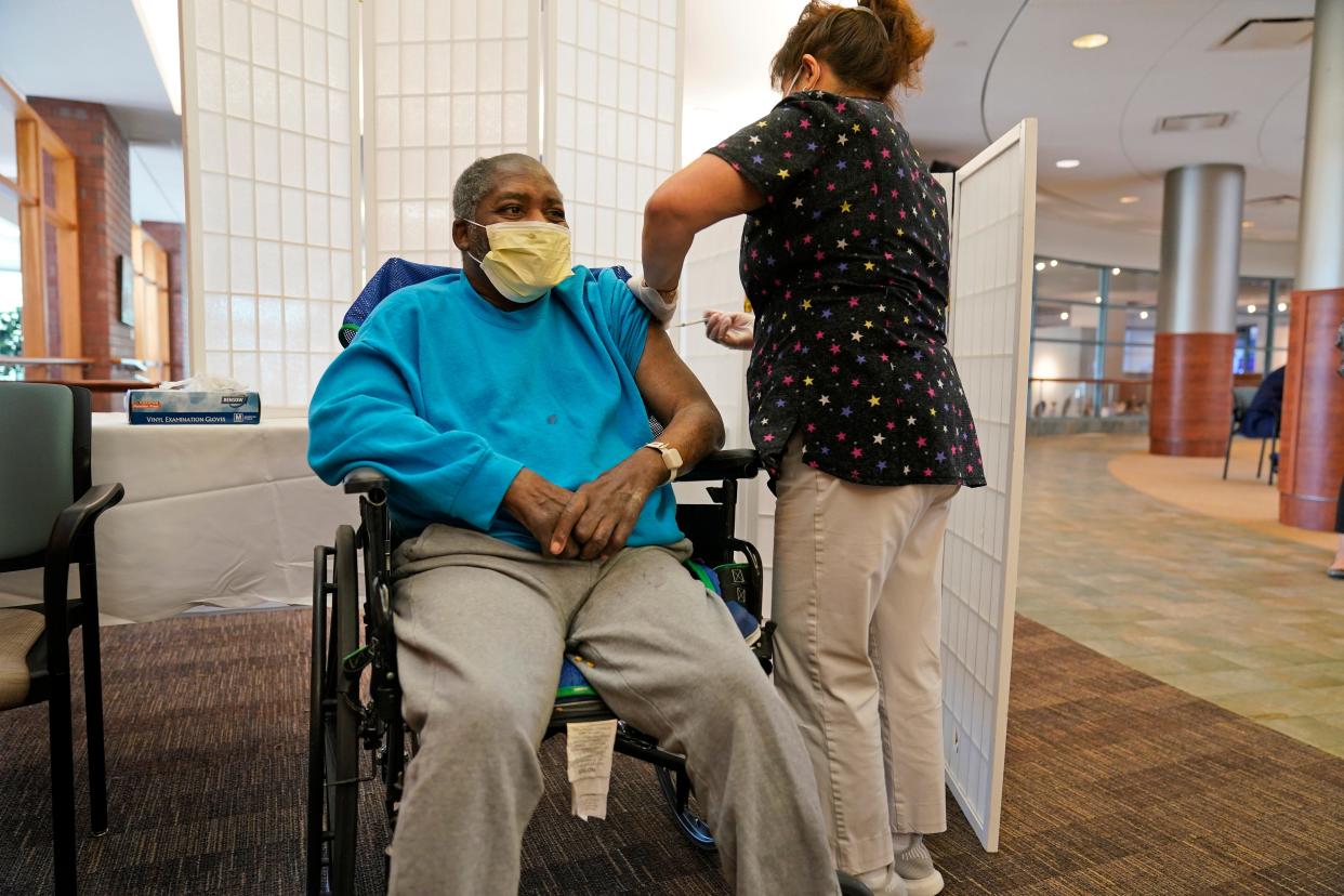 Edward Williams, 62, a resident at the Hebrew Home at Riverdale, N.Y., receives a COVID-19 booster shot.