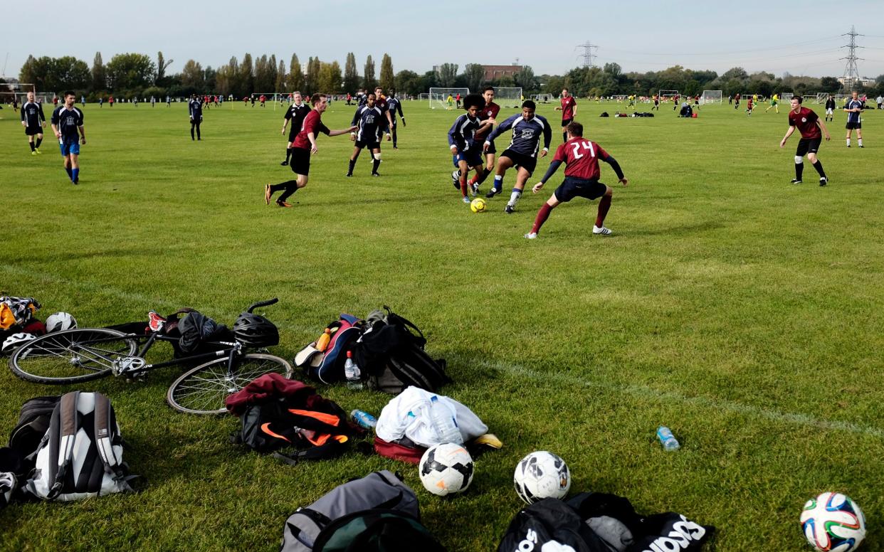 Players in action during Sunday morning Hackney & Leyton Football League matches at Hackney Marshes in London - Children’s team sport completely wiped out by second Covid-19 lockdown despite continued PE classes - GETTY IMAGES