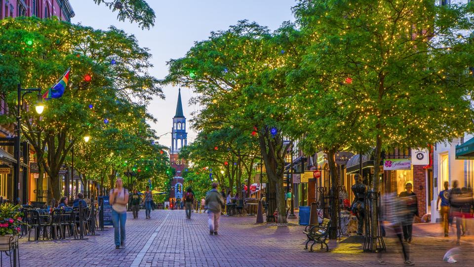 Church Street market at night with people walking during springtime in Burlington, Vermont.