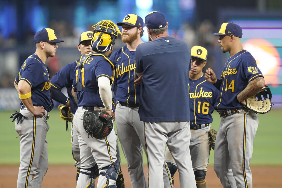 Milwaukee Brewers starting pitcher Brandon Woodruff, center, stands on the mound during the second inning of a baseball game against the Miami Marlins, Sunday, May 15, 2022, in Miami. (AP Photo/Lynne Sladky)