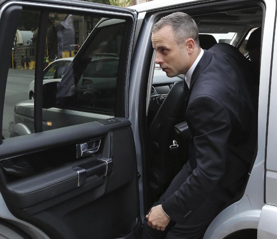 Oscar Pistorius arrives at the high court in Pretoria, South Africa, Tuesday, May 6, 2014. Using witness accounts of a panicked nighttime phone call from Pistorius begging for help and his desperate pleas for Reeva Steenkamp to stay alive, the defense at his murder trial tried to reinforce its case Monday that the double-amputee Olympian fatally shot his girlfriend in a tragic error of judgment. (AP Photo/Themba Hadebe)
