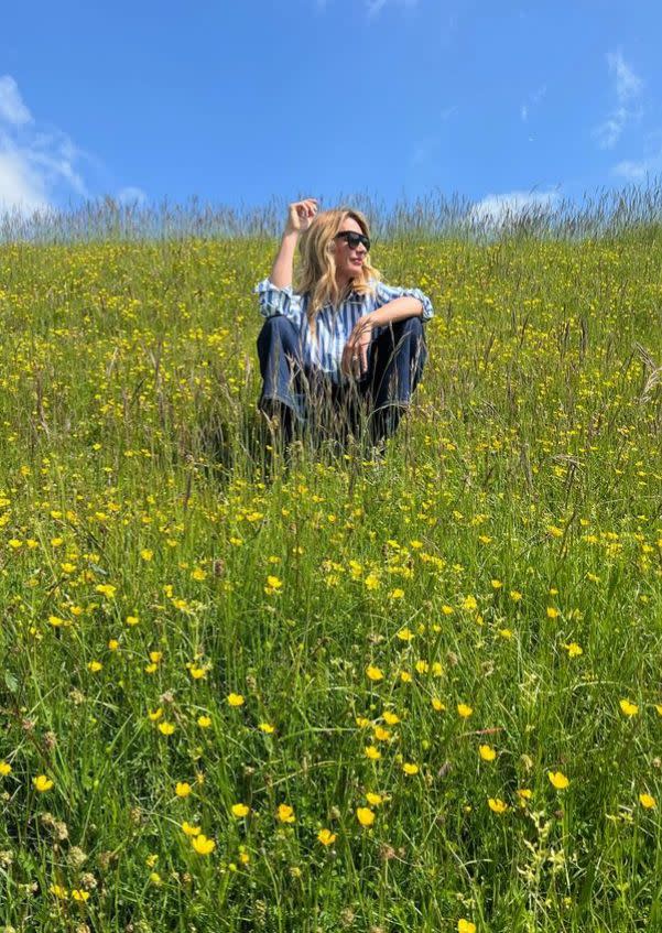 Cat Deeley sat in a field of buttercups