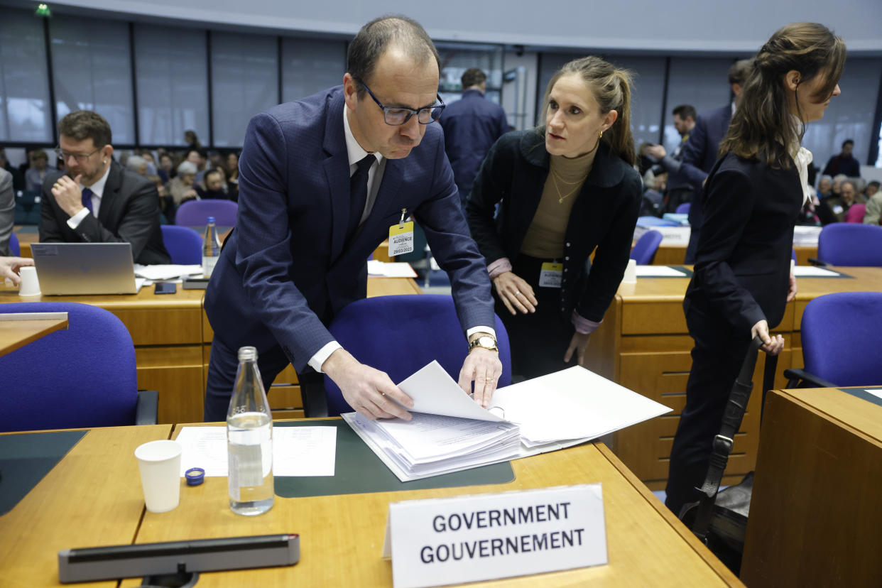 Switzerland's government representative Alain Chablais checks documents as he attends the hearing at the European Court of Human Rights Wednesday, March 29, 2023 in Strasbourg, eastern France. A group of Swiss seniors are taking their government to the European Court of Human Rights to demand more action on climate change, which they say is seriously affecting their lives. 