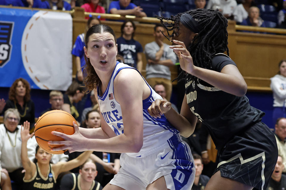 Duke's Mia Heide (42) looks to pass the ball while guarded by Colorado's Brianna McLeod during the first half of a second-round college basketball game in the NCAA Tournament, Monday, March 20, 2023, in Durham, N.C. (AP Photo/Karl B. DeBlaker)