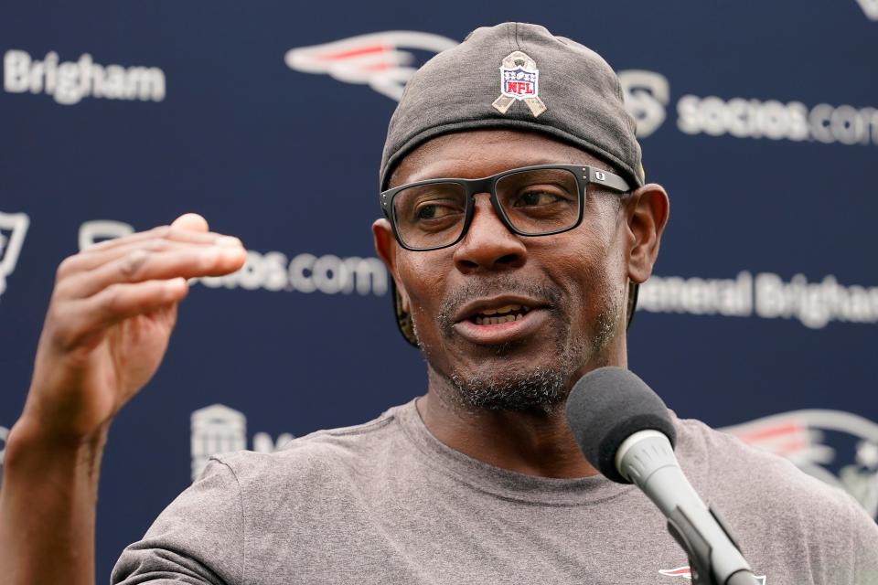 Patriots assistant coach Troy Brown talks with reporters after a training camp practice in August at Gillette Stadium.