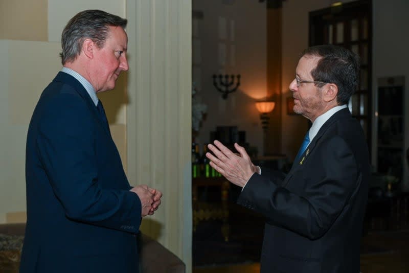 Israeli President Isaac Herzog (R) welcomes David Cameron (L), the British Foreign Secretary, ahead of a meeting at a hotel in Jerusalem Maayan Toaf/GPO/dpa