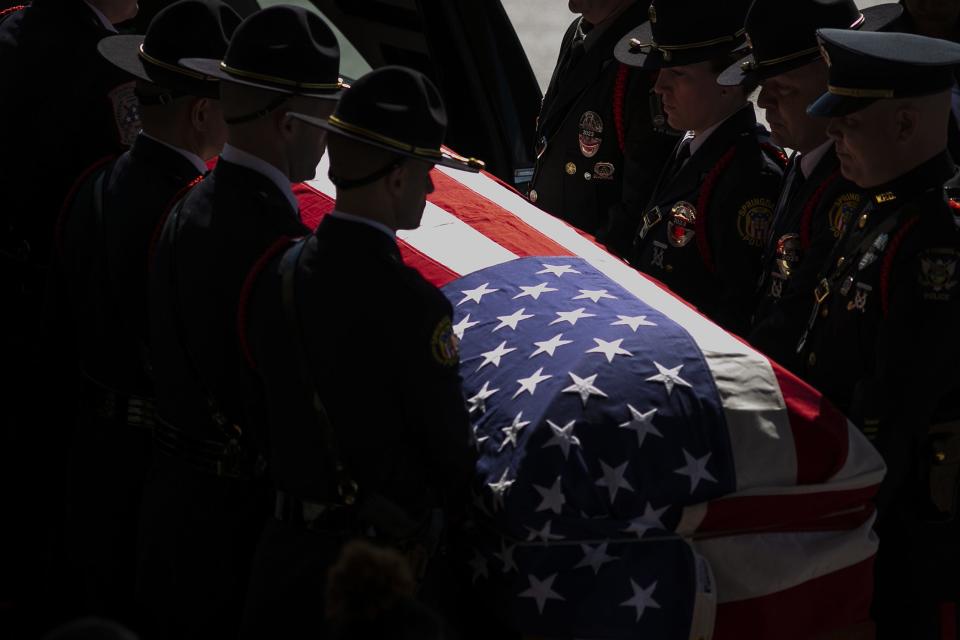 Springdale Police Department officers lift the casket of fellow officer Kaia Grant from the hearse for her funeral service at Vineyard Church in Springdale, March 29, 2020. Grant was killed in the line of duty March 21, 2020.