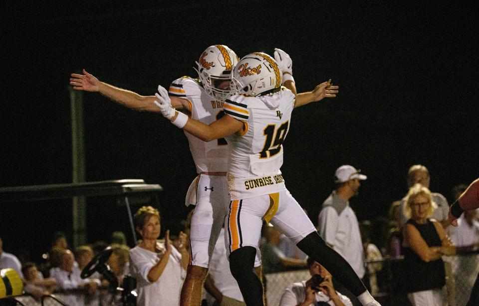 Carter Smith, left, the quarterback for the Bishop Verot football team is congratulated by teammate, Leo Berman after a touchdown during a game against the Cardinal Mooney football team at Bishop Verot on Friday, Oct. 20, 2023. Bishop Verot won.