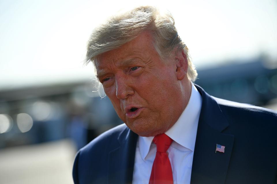 US President Donald Trump speaks to members of the media before departing from Phoenix Sky Harbor International Airport in Phoenix, Arizona on October 19, 2020. - US President Donald Trump went after top government scientist Anthony Fauci in a call with campaign staffers on October 19, 2020, suggesting the hugely respected and popular doctor was an "idiot." (Photo by MANDEL NGAN / AFP) (Photo by MANDEL NGAN/AFP via Getty Images)