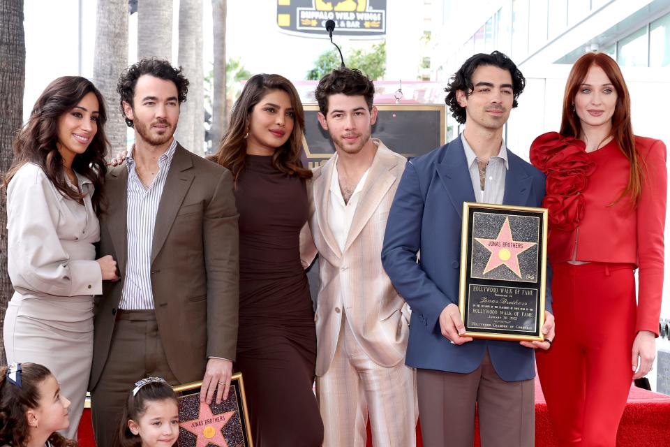 Danielle Jonas, Kevin Jonas, Priyanka Chopra, Nick Jonas, Joe Jonas, Sophie Turner, and (front) Alena Rose Jonas and Valentina Angelina Jonas attend The Hollywood Walk of Fame star ceremony honoring The Jonas Brothers on January 30, 2023 in Hollywood, California.