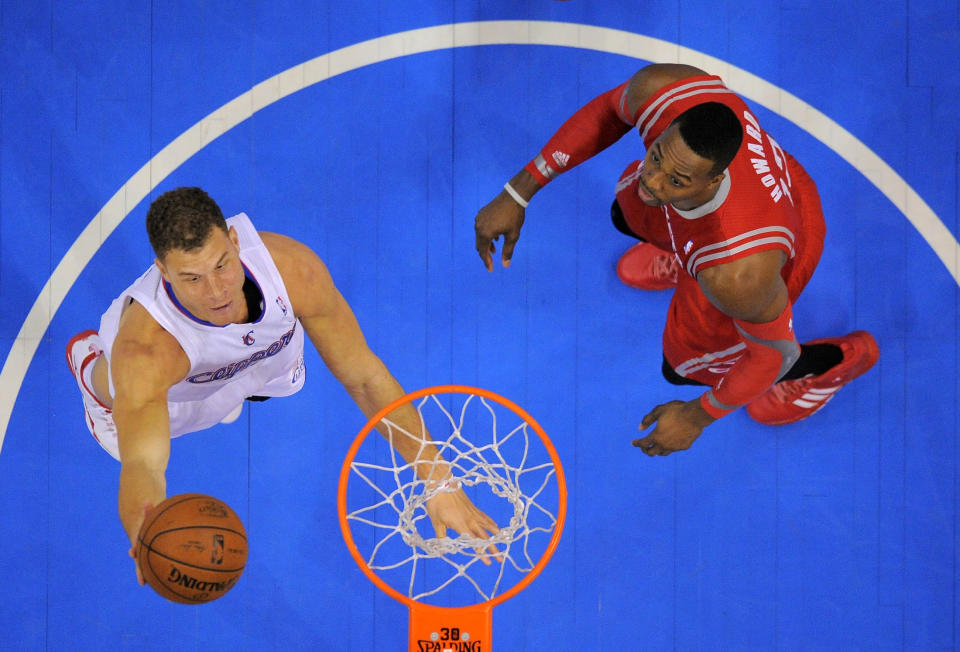 Los Angeles Clippers forward Blake Griffin, left, puts up a shot as Houston Rockets center Dwight Howard looks on during the first half of an NBA basketball game, Wednesday, Feb. 26, 2014, in Los Angeles. (AP Photo/Mark J. Terrill)