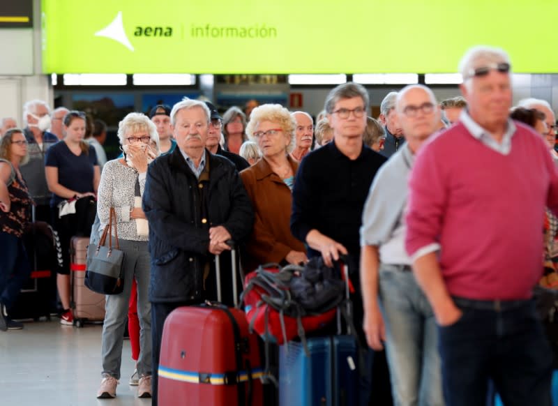 Tourists at Gran Canaria airport wait to return to their countries after closure of hotels