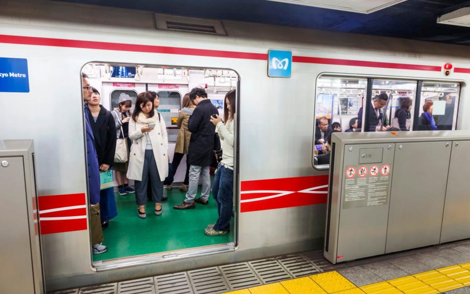 The scheme is being tested on the notoriously busy Tozai line, which between 7.50am and 8.50am carries around to 70,000 people - around 199% of its loading capacity. - Universal Images Group Editorial