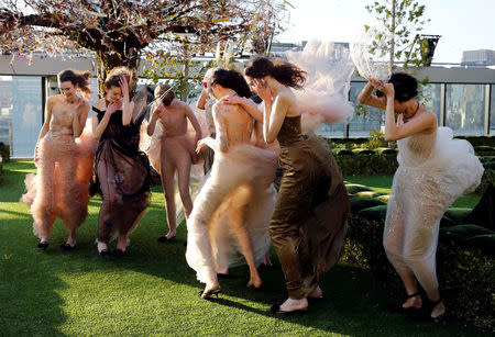 Models struggle against strong wind before the rehearsal of Christian Dior's Haute Couture Spring-Summer 2017 live show to celebrate Dior's new flagship store at the rooftop of Ginza Six mall in Tokyo, Japan, April 19, 2017. REUTERS/Toru Hanai