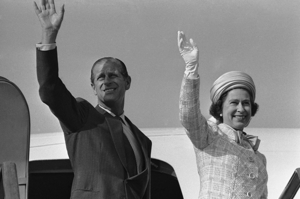 Britain's Queen Elizabeth II and her husband Prince Philip wave from plane ramp shortly before the special royal plane took off from Tokyo, May 12, 1975.