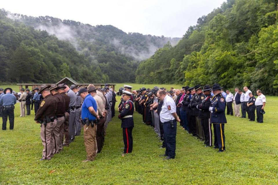 Mourners attend the burial for Prestonsburg Police Captain Ralph Frasure as he was laid to rest at the Gethsemane Gardens in Presontsburg, Ky., on Wednesday, July 6, 2022. Frasure was killed when a man with a rifle opened fire on police attempting to serve a warrant Thursday.