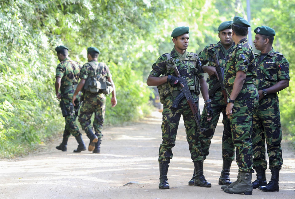 Security personnel patrol outside a polling station during the country's presidential election in Weerawila, Sri Lanka, Saturday, Nov. 16 , 2019. A convoy of buses carrying Muslim voters traveling in northern Sri Lanka was attacked by gunfire and stones, and blocked by burning tires, around midnight on Saturday hours before polls opened in Sri Lanka’s presidential election, according to Colombo-based Centre for Monitoring Election Violence. (AP Photo/Chamila Karunarathne )