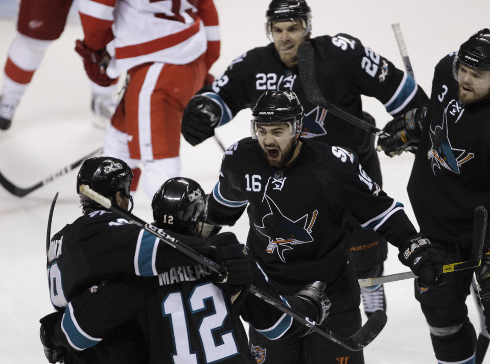 FILE - San Jose Sharks right wing Devin Setoguchi (16) celebrates after he assisted center Patrick Marleau (12) on a score against the Detroit Red Wings during the third period of Game 7 of an NHL hockey Stanley Cup Western Conference semifinal, May 12, 2011, in San Jose, Calif. The Red Wings trailed 3-0 in the series, then tied it at 3. But the Sharks won Game 7. (AP Photo/Paul Sakuma, File)