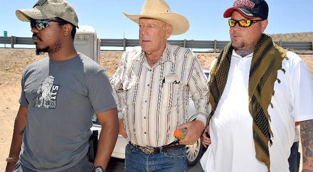 Rancher Cliven Bundy (centre) arrives with body guards before a news conference near his ranch on April 24, 2014 in Bunkerville, Nevada. Photo: AFP/David Becker.