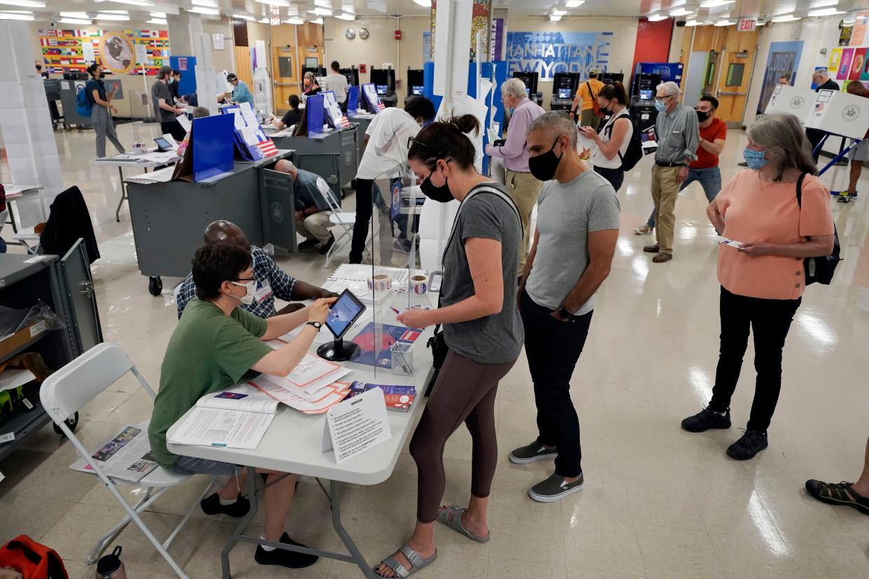 Voters sign in at Frank McCourt High School, in New York on Tuesday, June 22, 2021.