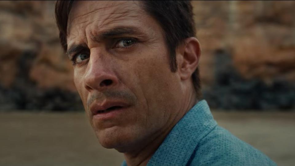 Gael Garcia Bernal's noticeably wizened face turns apprehensively toward the camera at the horror he is to find in the movie Old.