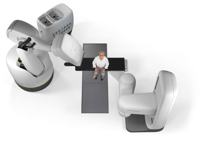 Accuray CyberKnife system with a man sitting in the middle