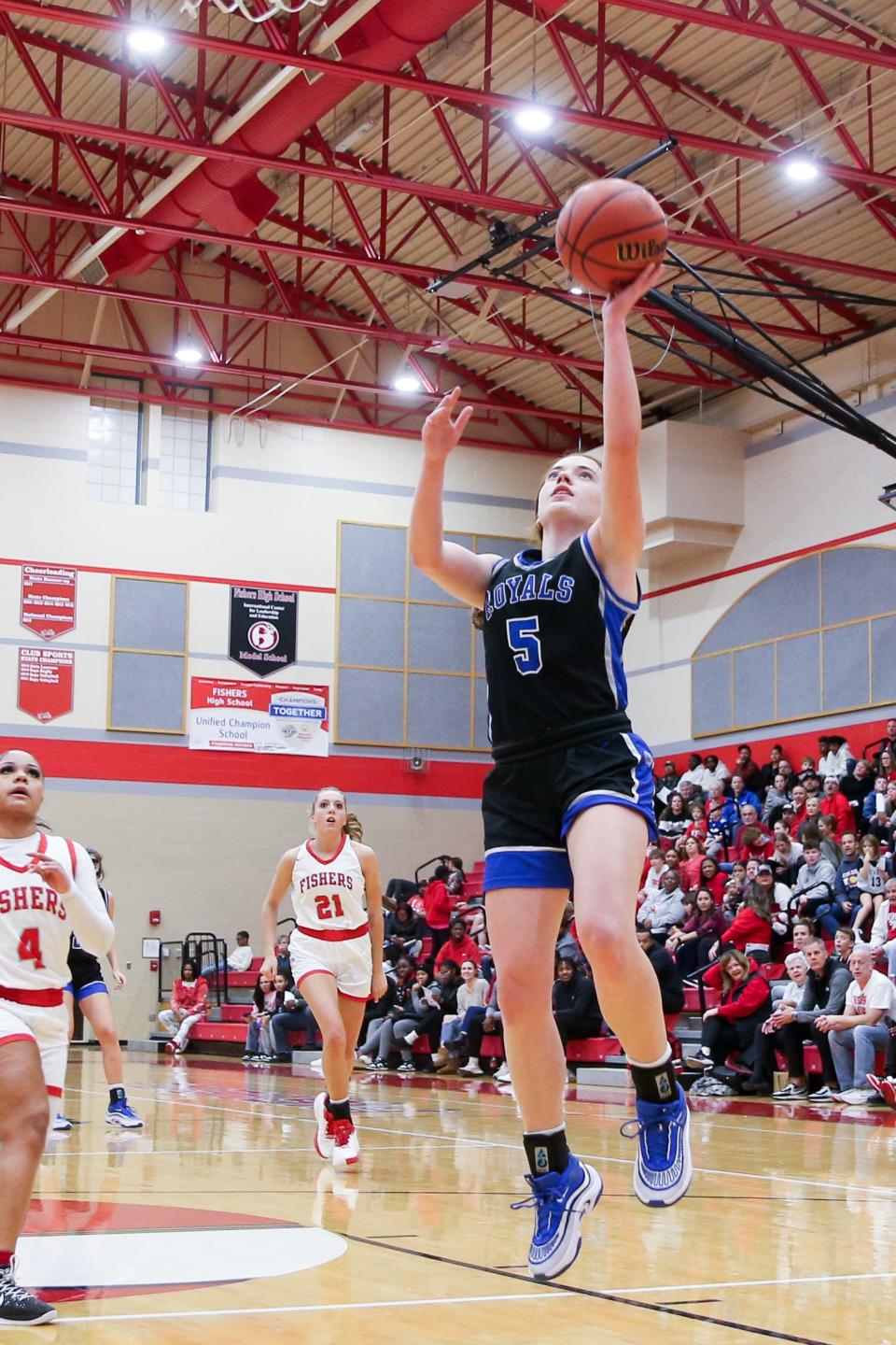 Hamilton Southeastern's Kayla Brinley (5) drives in for the shot during Fishers vs Hamilton Southeastern high school in Mudsock girls basketball held Dec 16, 2023; Fishers, IN, USA; at Fishers High School.
