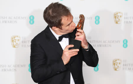 Sam Rockwell holds his award for Supporting Actor for Three Billboards Outside Ebbing Missouri at the British Academy of Film and Television Awards (BAFTA) at the Royal Albert Hall in London, Britain, February 18, 2018. REUTERS/Hannah McKay