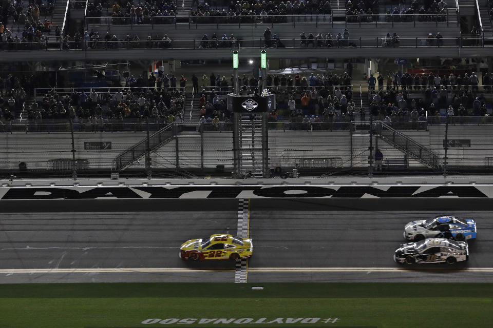 Joey Logano (22) beats Ryan Newman (6) and Aric Almirola (10) to the finish line to win the first of two NASCAR Daytona 500 qualifying auto races Thursday, Feb. 13, 2020, at Daytona International Speedway in Daytona Beach, Fla. (AP Photo/Chris O'Meara)