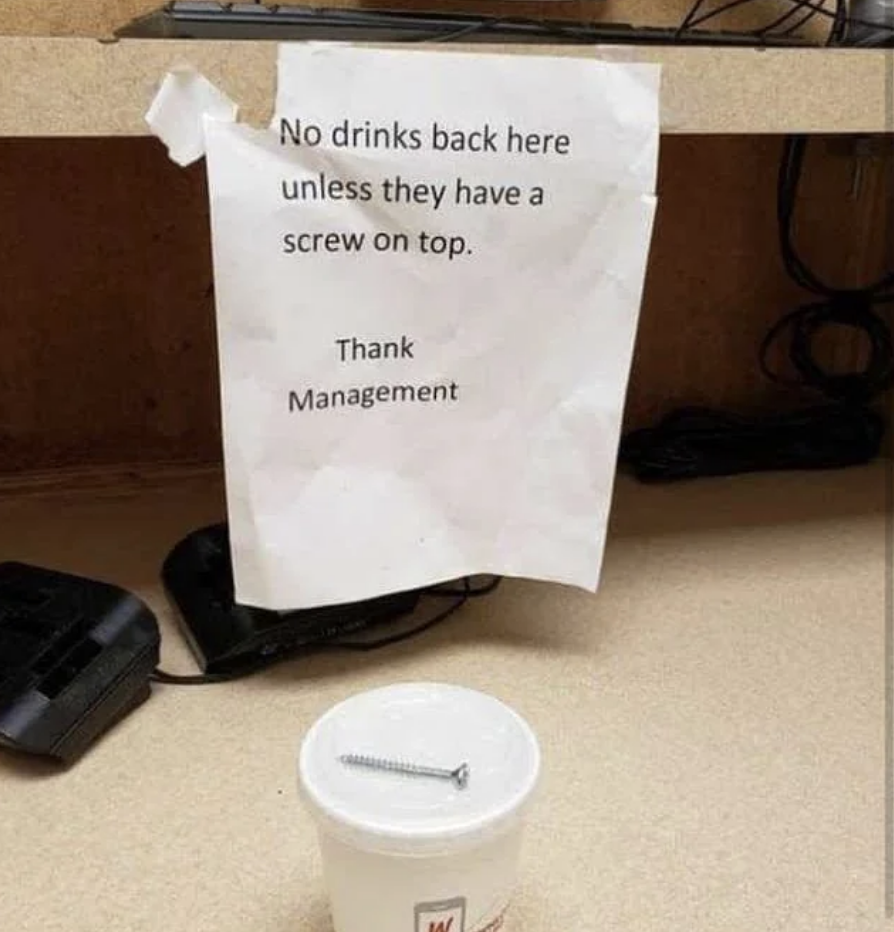 Sign reads "No drinks back here unless they have a screw on top. Thank Management," with cup and screw illustrating the joke