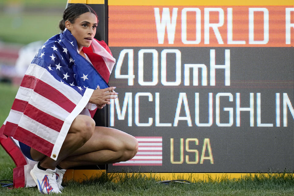 FILE - Gold medalist Sydney McLaughlin, of the United States, poses by a sign after winning the final of the women's 400-meter hurdles at the World Athletics Championships on July 22, 2022, in Eugene, Ore. World-record setters McLaughlin-Levrone and Armand "Mondo" Duplantis were named World Athletes of the Year on by track's international governing body Monday, Dec. 5, adding yet another achievement to a remarkable 2022 for both athletes. (AP Photo/Ashley Landis, File)