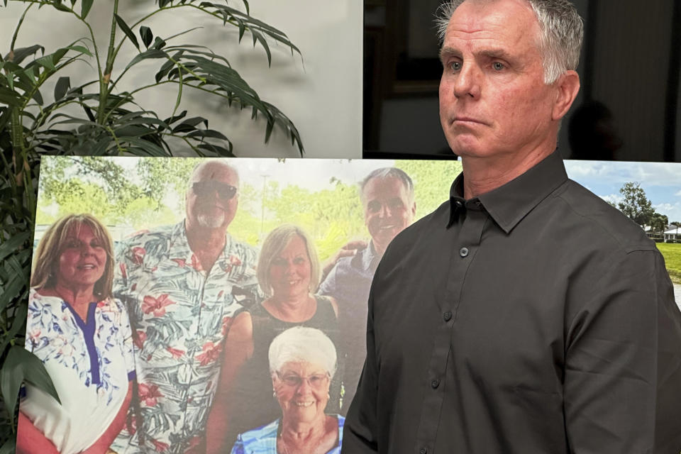 Bill Serge stands next to a photo on Thursday, Jan. 25, 2024, in West Palm Beach, Fla. of his 85-year-old mother, Gloria Serge, who was killed in an alligator attack on Feb. 20, 2023. The Serge family filed a lawsuit Thursday against the Wynne Building Corp., which owns the Spanish Lakes senior complex in Fort Pierce where the attack occurred. (AP Photo/Terry Spencer)