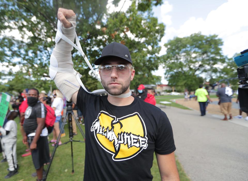 Gaige Grosskreutz, 26, who was shot in the arm during protests in Kenosha, Wis., marches through the streets of Milwaukee on Sept. 5.