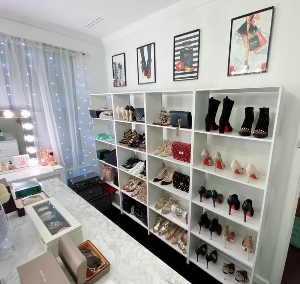 Designer shoes and handbags displayed on a bookshelf