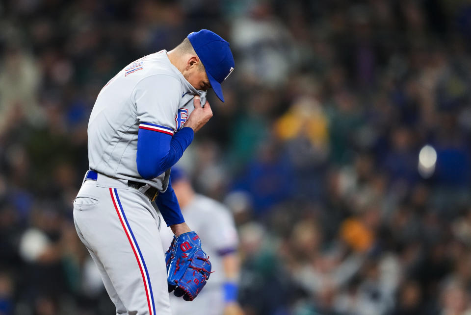 Texas Rangers starting pitcher Nathan Eovaldi reacts after hitting Seattle Mariners' Ty France with a pitch to load the bases during the fourth inning of a baseball game Friday, Sept. 29, 2023, in Seattle. (AP Photo/Lindsey Wasson)