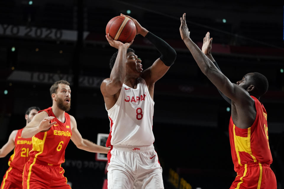 Japan's Rui Hachimura (8) looks to shoot between Spain's Sergio Rodriguez (6) and Usman Garuba during a men's basketball preliminary round game at the 2020 Summer Olympics in Saitama, Japan, Monday, July 26, 2021. (AP Photo/Charlie Neibergall)