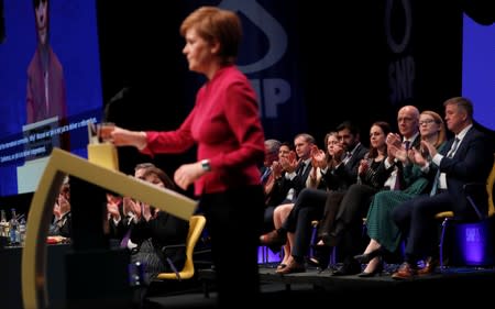 Scotland's First Minister Nicola Sturgeon is applauded by the cabinet as she delivers her speech at the SNP autumn conference in Aberdeen, Scotland