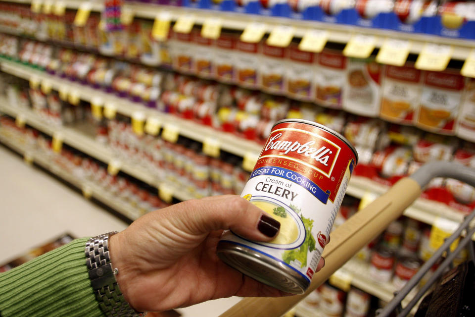 A customer holds a can of cream of celery Campbell's Soup at a grocery store in Phoenix, Arizona, February 22, 2010.  Campbell's Soup Co has been having a tough time getting its soups from the store shelf to the home pantry. Campbell's U.S. soup sales fell 8 percent during the usually strong late fall and winter months, the company said on Monday. While the economy remains weak, shoppers are being lured by other prepared foods such as frozen dinners, that may be promoted at lower prices.   REUTERS/Joshua Lott (UNITED STATES
 - Tags: BUSINESS)