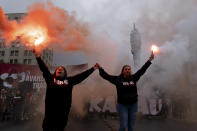 Protesters hold flares as they march on International Workers' Day in Santiago, Chile, Wednesday, May 1, 2024. (AP Photo/Matias Basualdo)