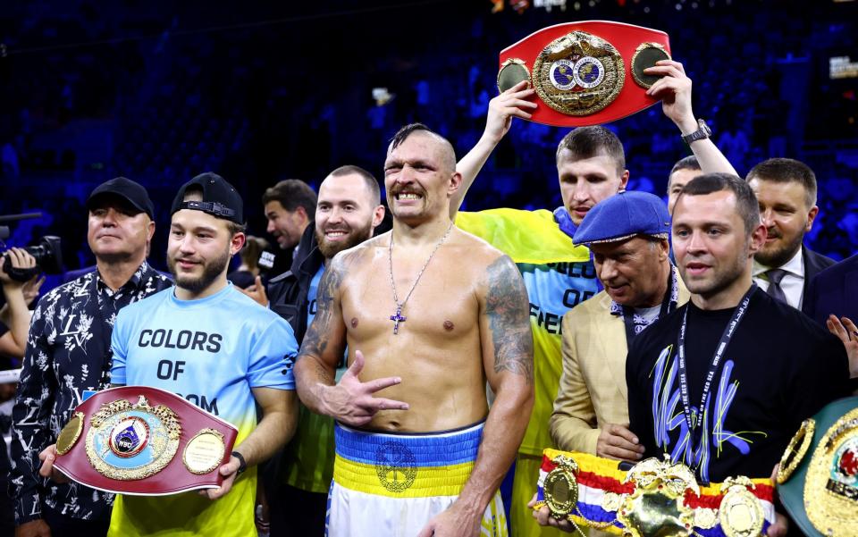 Oleksandr Usyk celebrates with their belts and team after their victory over Anthony Joshua - GETTY IMAGES