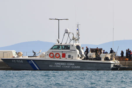 A Hellenic Coast Guard vessel carrying the bodies of migrants that were drowned when the small boat they were travelling on capsized near the island of Agathonisi, is moored the port of Pythagoreio on the island of Samos, Greece, March 17, 2018. SamosTimes.gr via REUTERS