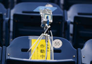 This photo shows a device to detect carbon dioxide installed in the seats of a baseball stadium, home for the Yokohama DeNA BayStars, in Yokohama, south of Tokyo on Friday, Oct. 30, 2020. The device was introduced during a media tour Friday. (AP Photo/Hiro Komae)