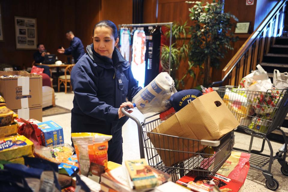 Jackie Ramirez, a Coast Guard Academy instructor, picks up donated items at a pop-up food pantry for Coast Guard members who are without pay during the government shutdown. (Photo: Hayley Miller/HuffPost)