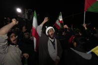 Iranian demonstrators chant slogans during their anti-Israeli gathering in front of the British Embassy in Tehran, Iran, early Sunday, April 14, 2024. Iran launched its first direct military attack against Israel on Saturday. (AP Photo/Vahid Salemi)