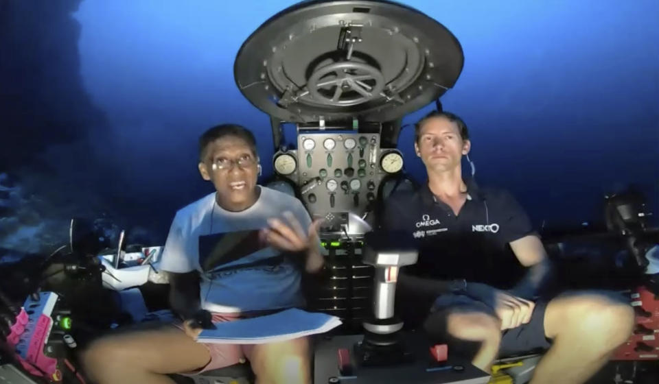 An image taken from video issued by Nekton shows Seychelles President Danny Faure, left, speaking from inside a submersible from the vessel Ocean Zephyr, under the water off the coast of Desroches, in the outer islands of Seychelles Sunday April 14, 2019. Faure toured the vessel and was presented with some of the findings and observations made by a British-led science expedition documenting changes taking place beneath the waves that could affect billions of people in the surrounding region over the coming decades (Nekton via AP)