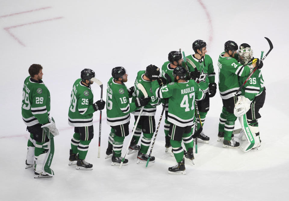 Dallas Stars goalie Anton Khudobin (35) and teammates celebrate a win over the Vegas Golden Knights during Game 4 of the NHL hockey Western Conference final, Saturday, Sept. 12, 2020, in Edmonton, Alberta. (Jason Franson/The Canadian Press via AP)