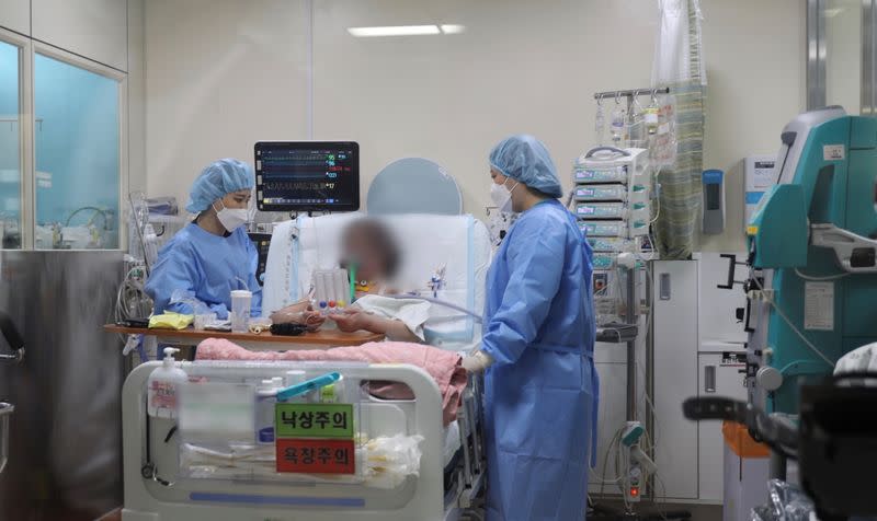A former coronavirus disease (COVID-19) patient who underwent lung transplant surgery, takes a remedial exercise at Hallym Sacred Heart Hospital ECMO Center in Anyang